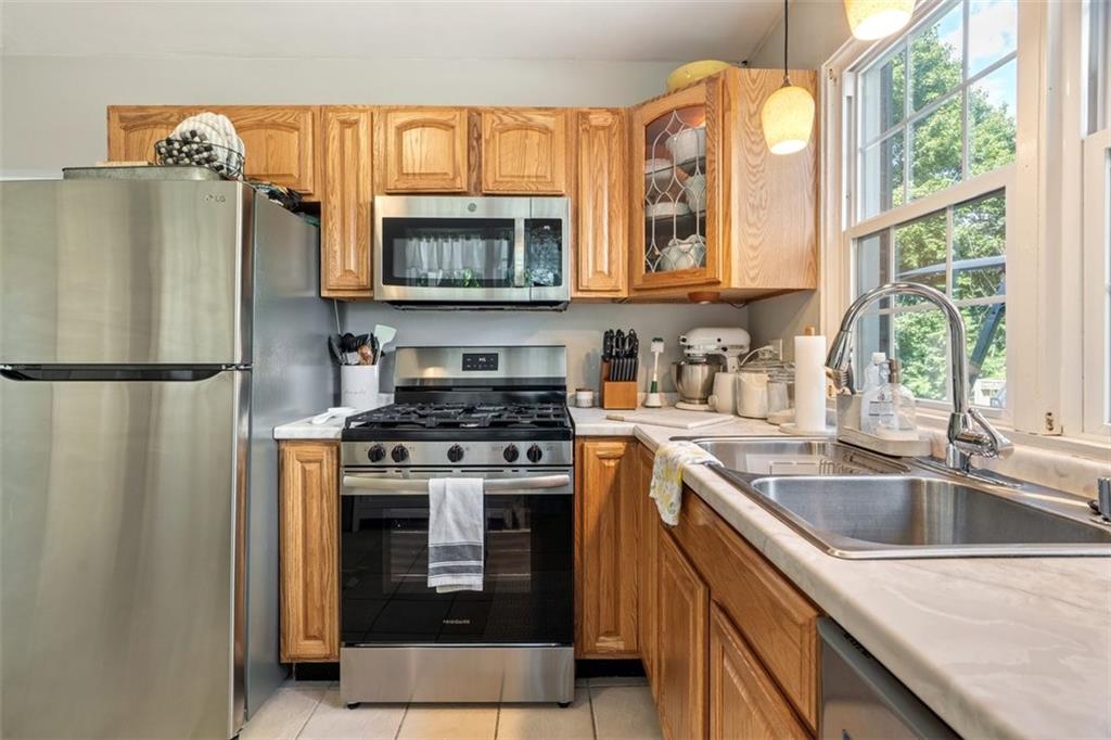 694 Oak Street Crescent, PA 15046 - Photo 18 of 19 a kitchen with stainless steel appliances granite countertop a refrigerator a sink a stove and a microwave