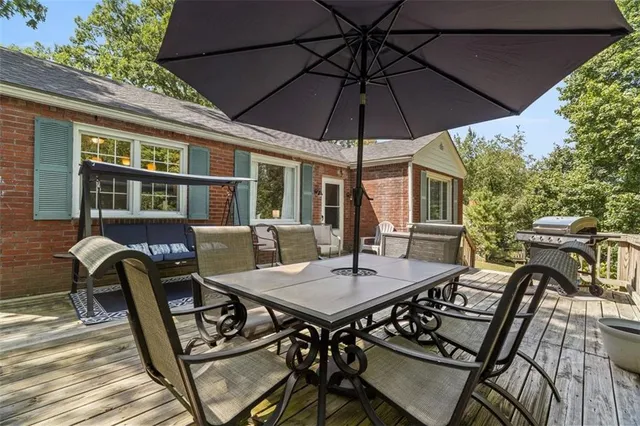 a view of a patio with a table and chairs under an umbrella