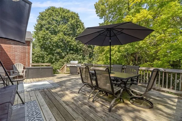 a view of deck with furniture and umbrella