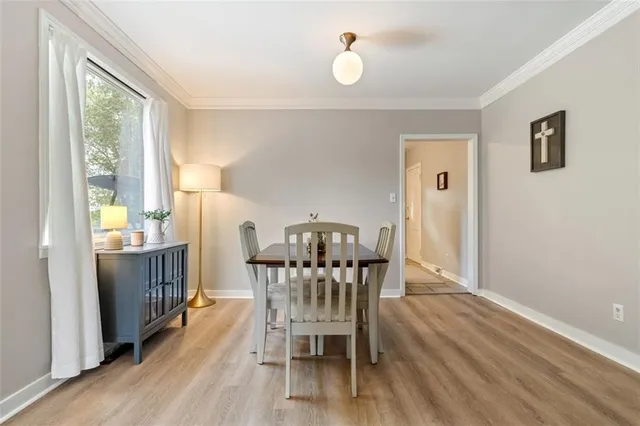 a view of a dining room with furniture window and wooden floor