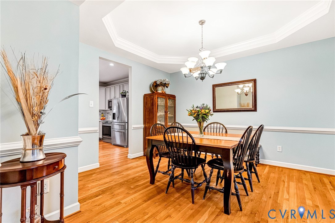 14436 Overlook Ridge Lane Beaverdam, VA 23015 - Photo 20 of 82 a view of a dining room with furniture a chandelier and wooden floor