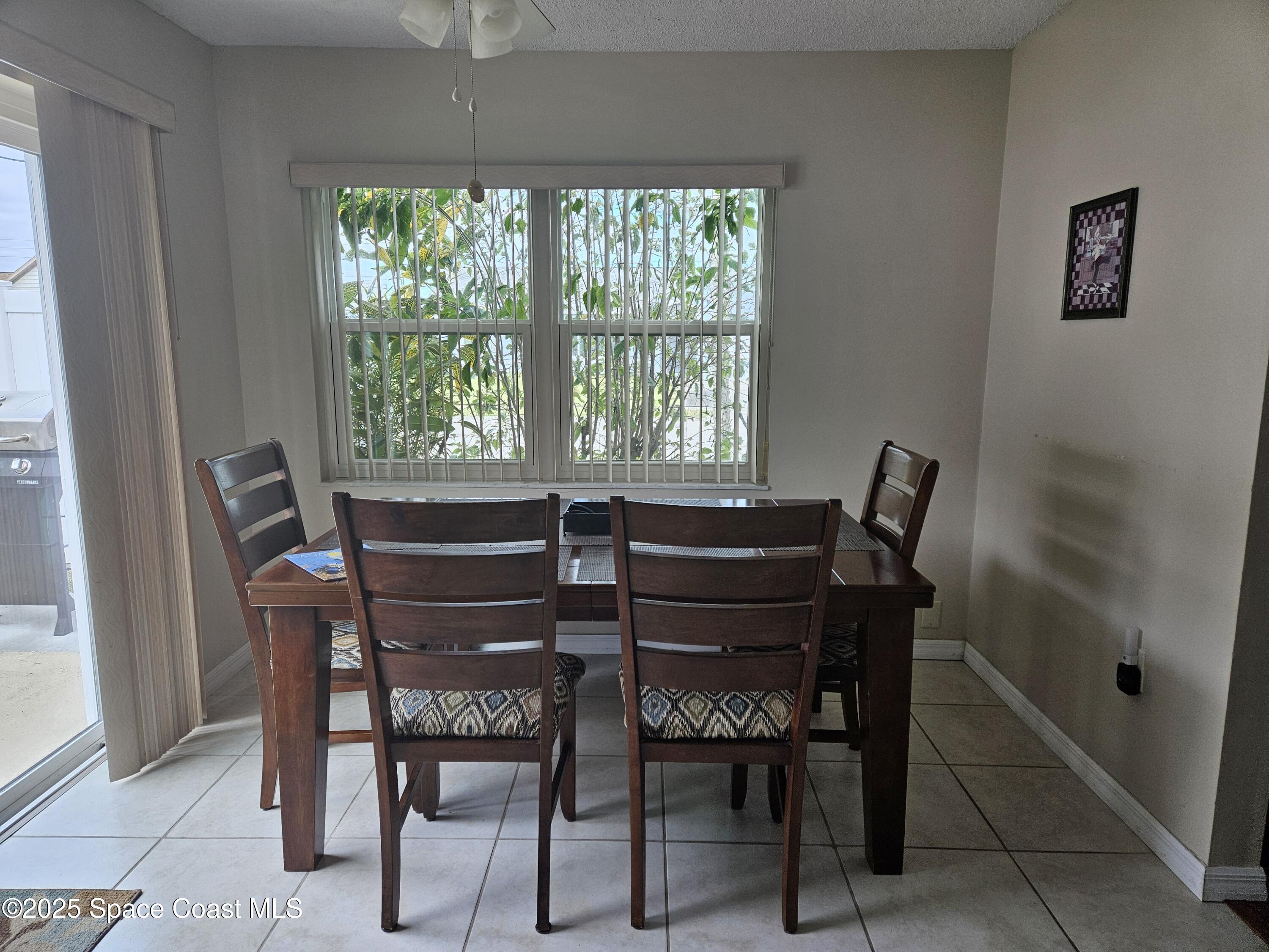 813 Pine Shadows Avenue Rockledge, FL 32955 - Photo 11 of 32 a view of a dining room with furniture and a window
