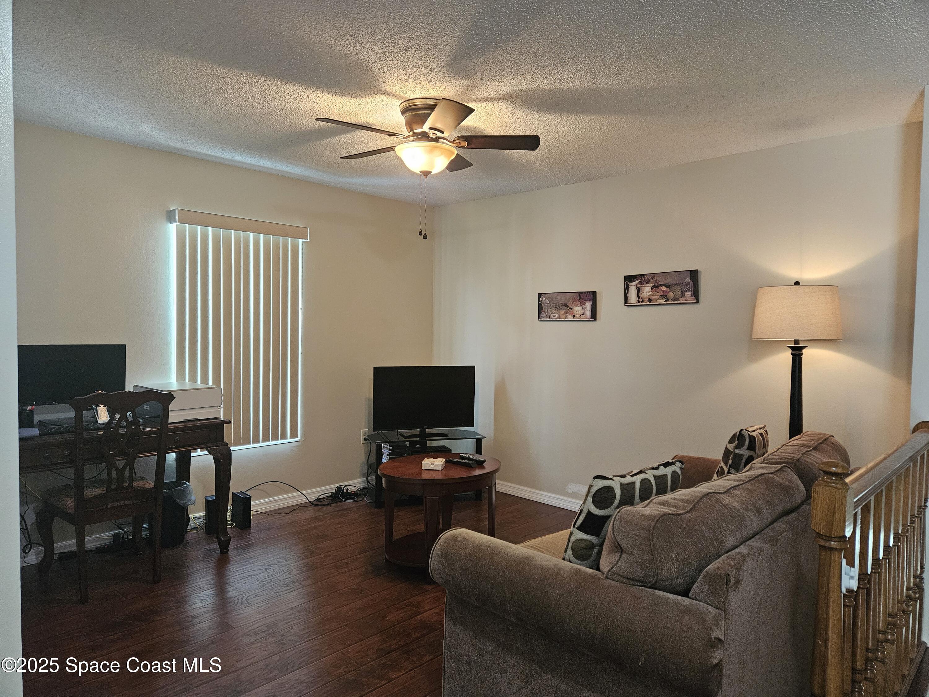 813 Pine Shadows Avenue Rockledge, FL 32955 - Photo 19 of 32 a living room with furniture and a flat screen tv