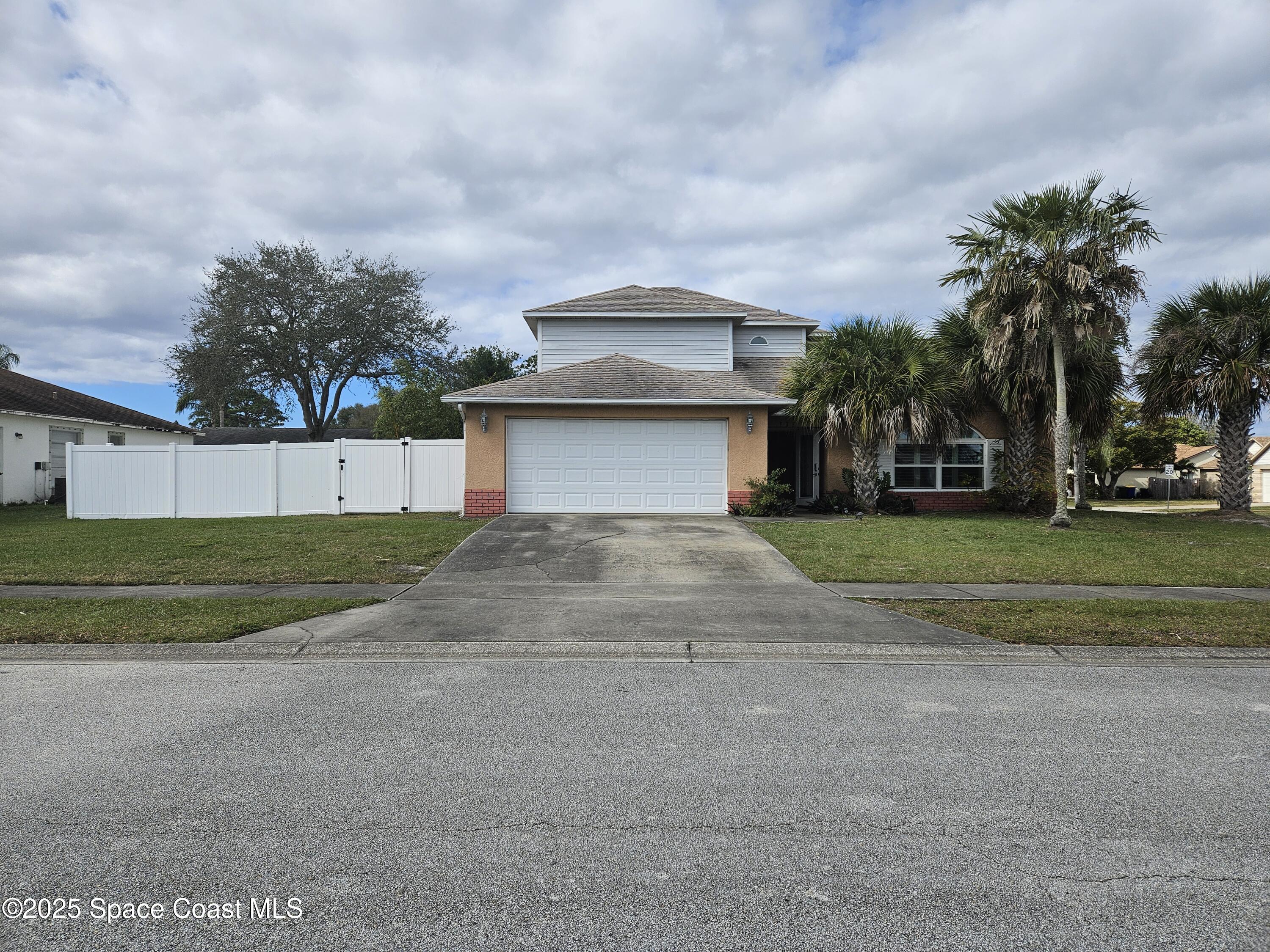 813 Pine Shadows Avenue Rockledge, FL 32955 - Photo 2 of 32 a front view of a house with a yard and garage
