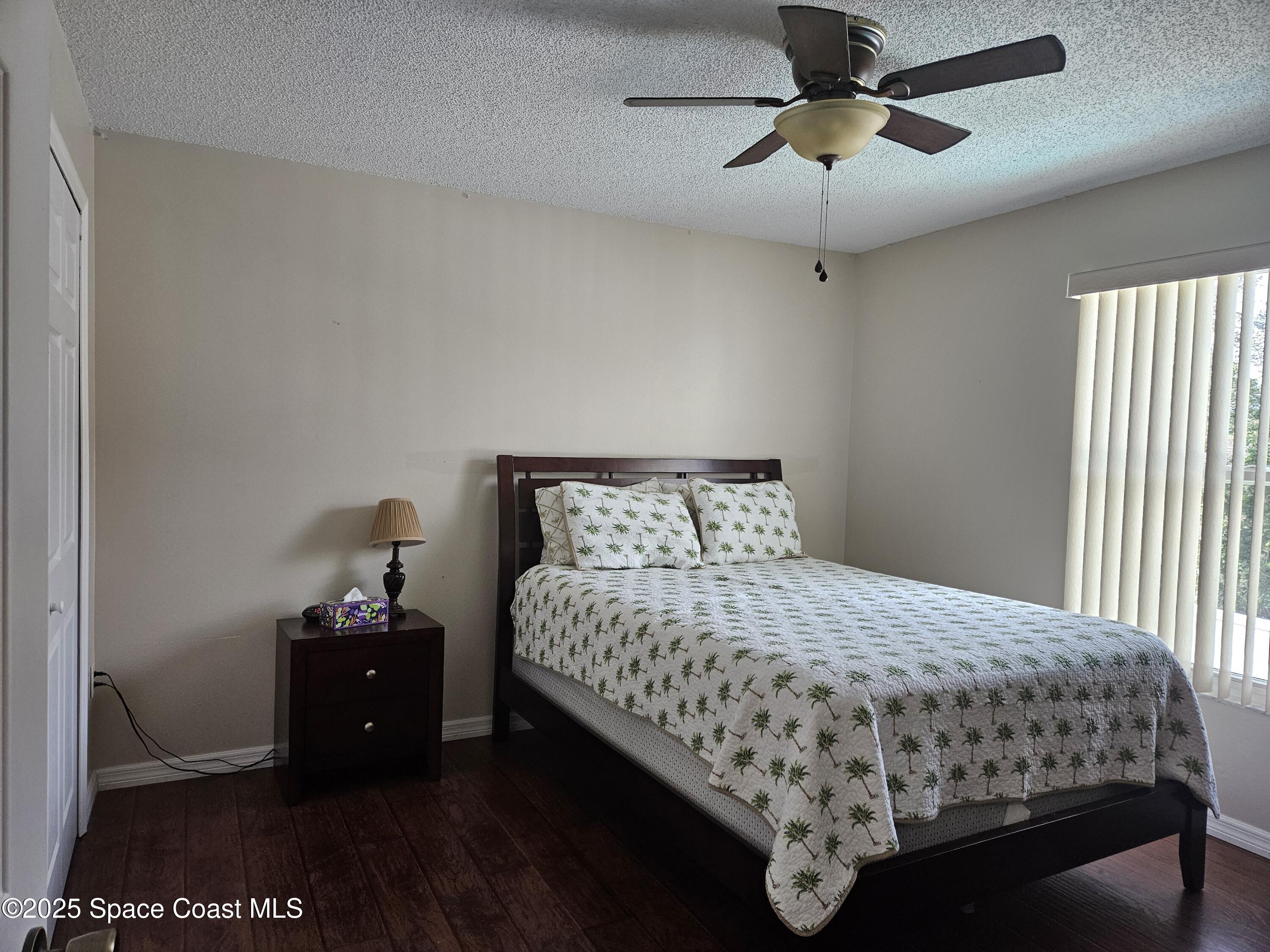 813 Pine Shadows Avenue Rockledge, FL 32955 - Photo 21 of 32 a bedroom with a bed and a chandelier