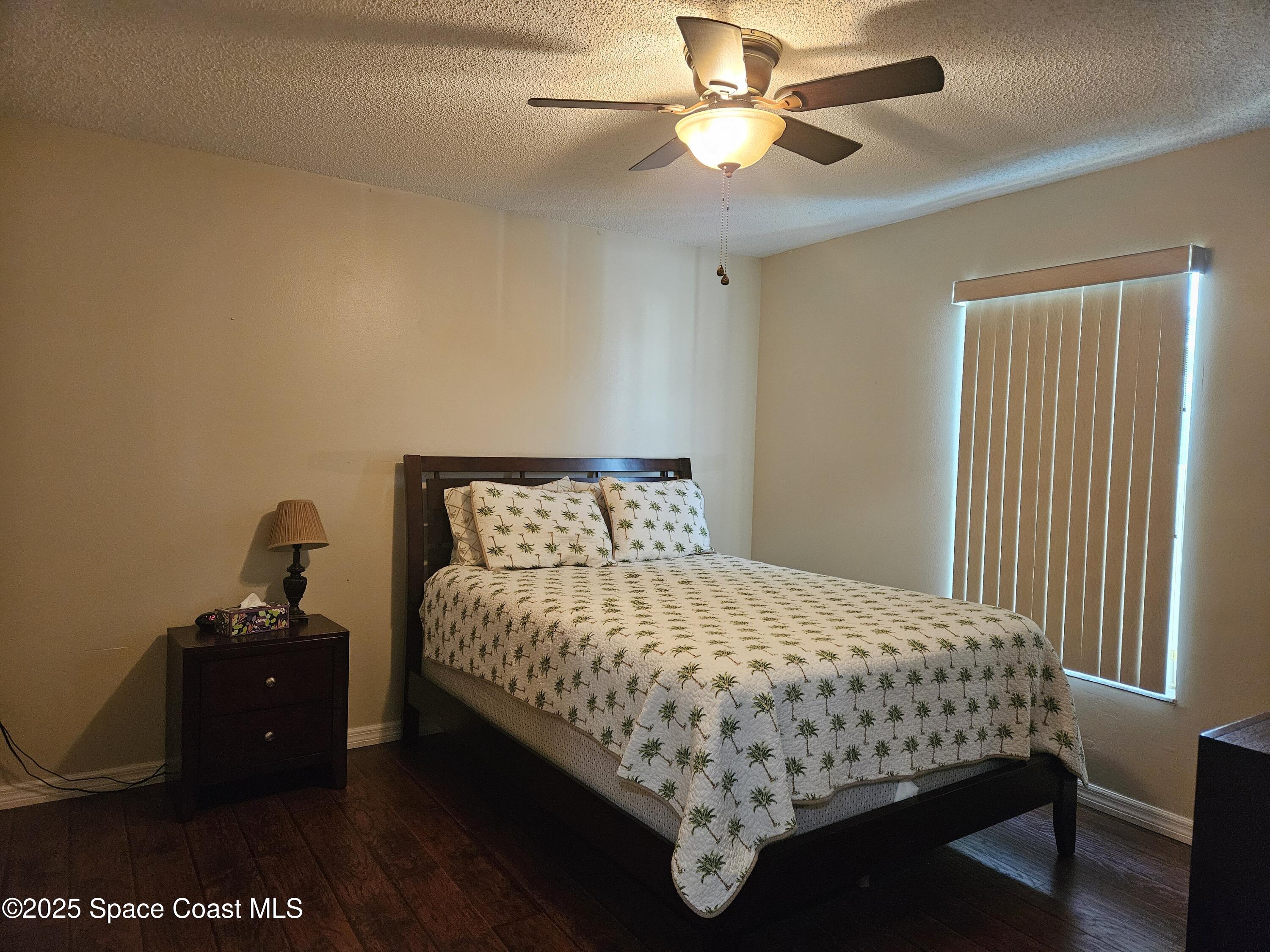 813 Pine Shadows Avenue Rockledge, FL 32955 - Photo 22 of 32 a bedroom with a bed and a chandelier