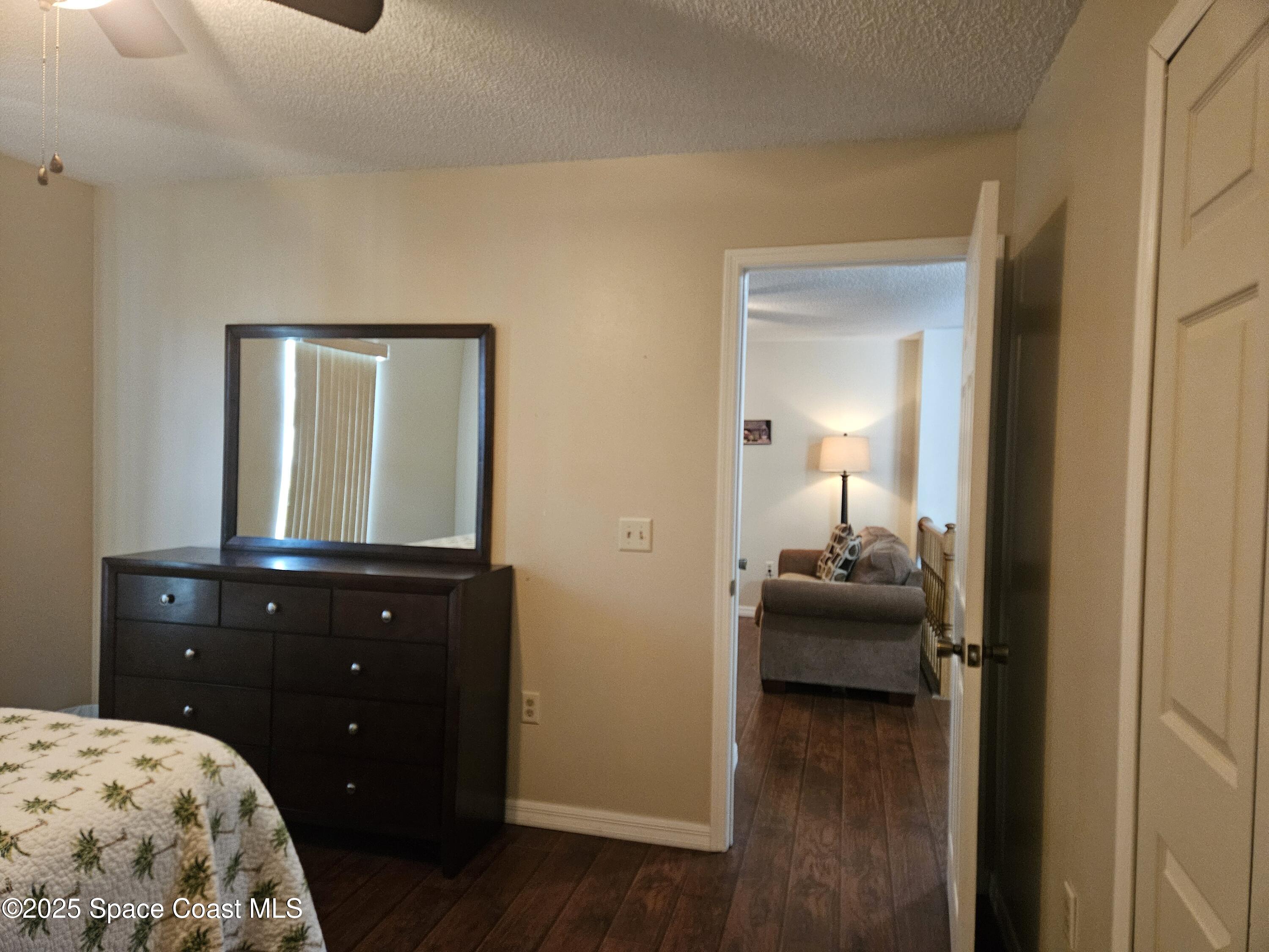 813 Pine Shadows Avenue Rockledge, FL 32955 - Photo 23 of 32 a bedroom with a bed and wooden floor