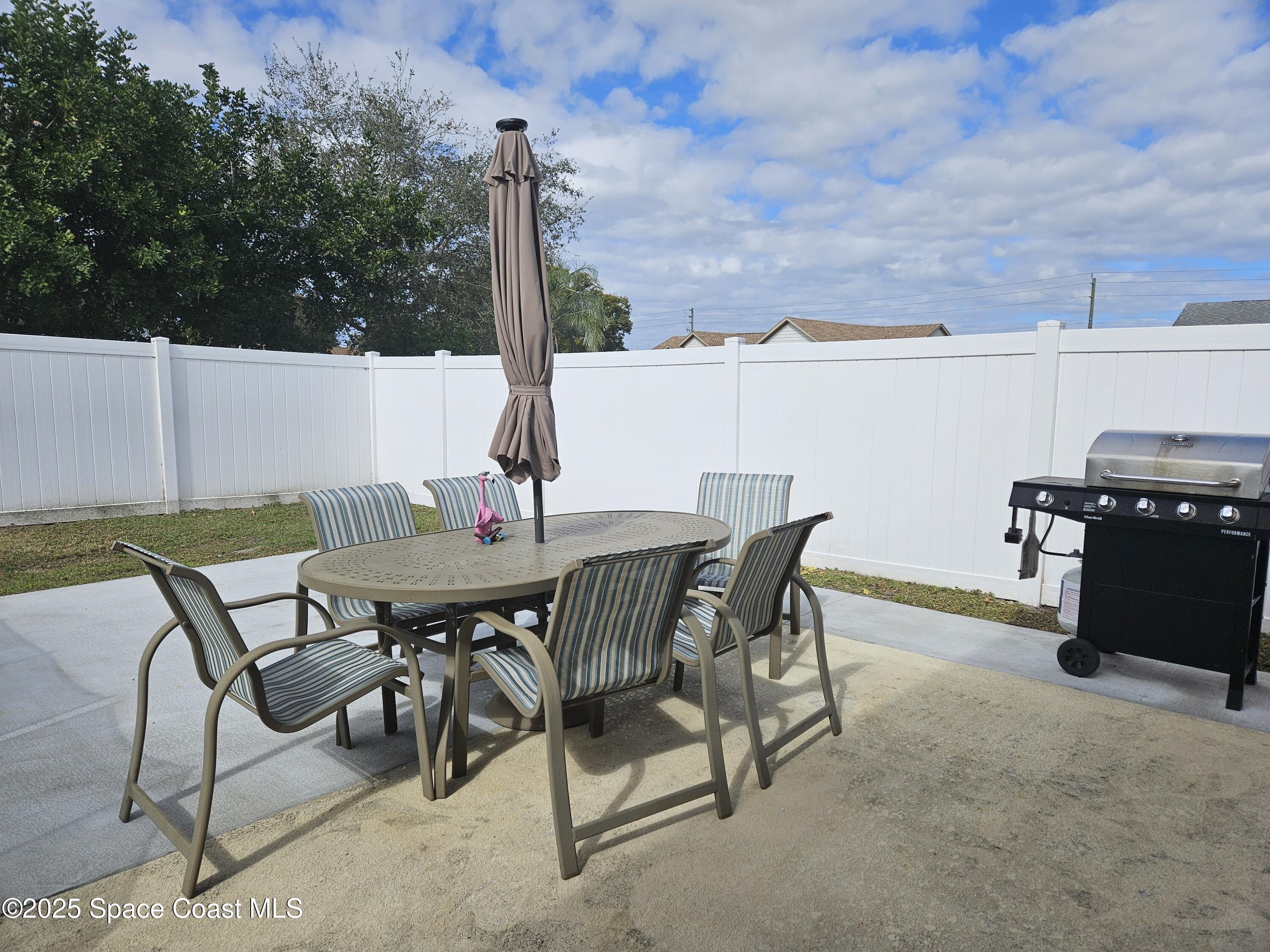 813 Pine Shadows Avenue Rockledge, FL 32955 - Photo 31 of 32 a view of an outdoor space with table and chairs