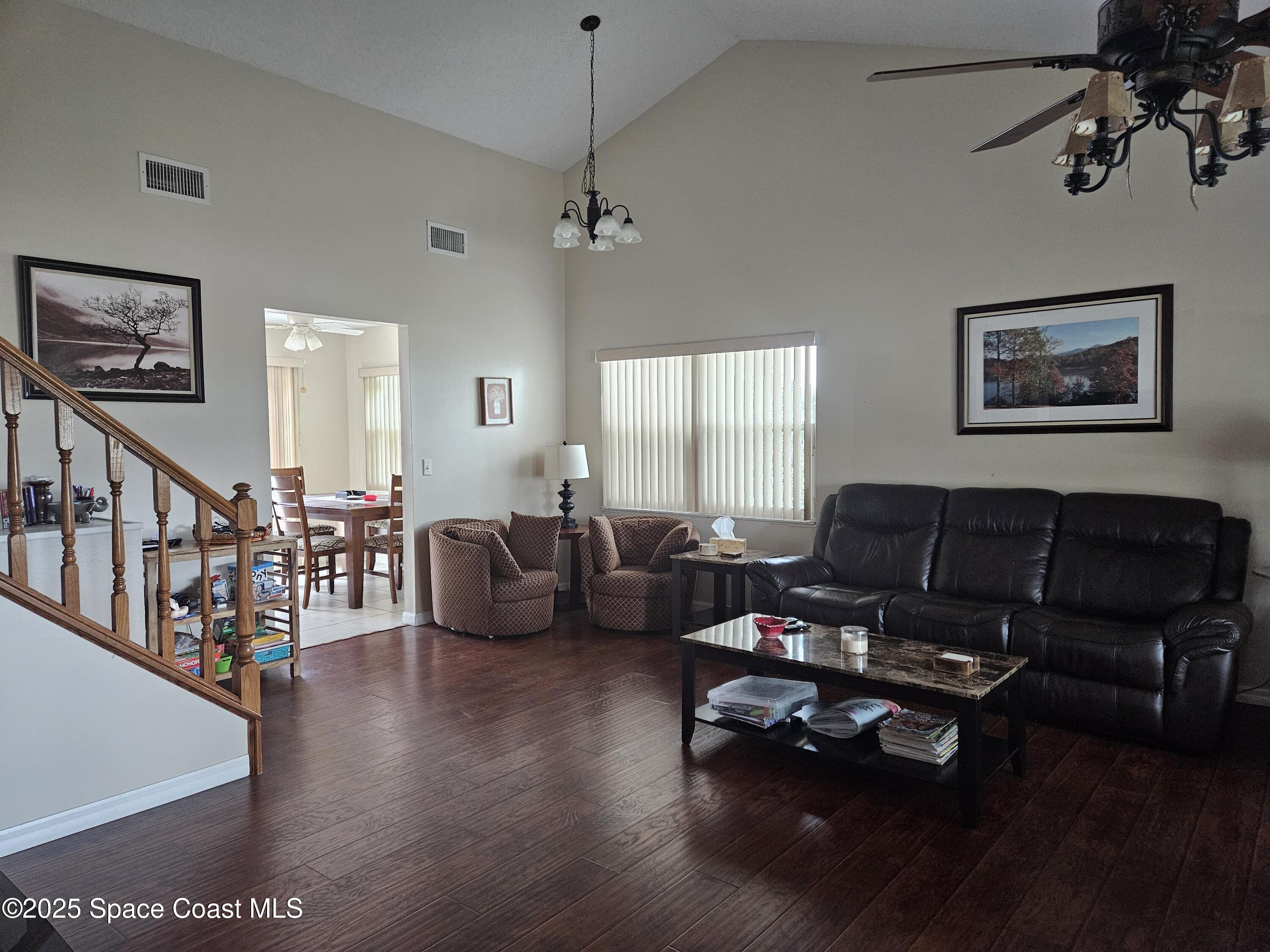 813 Pine Shadows Avenue Rockledge, FL 32955 - Photo 9 of 32 a living room with furniture couches and a dining table with wooden floor