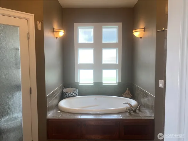 a bath tub sitting in a bathroom next to a window