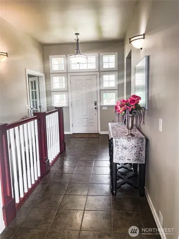 a view of a dining room with furniture and chandelier