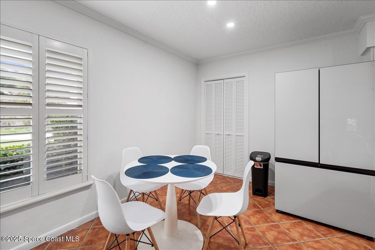2175 Barracuda Avenue Melbourne Beach, FL 32951 - Photo 11 of 49 a table and chairs in a room