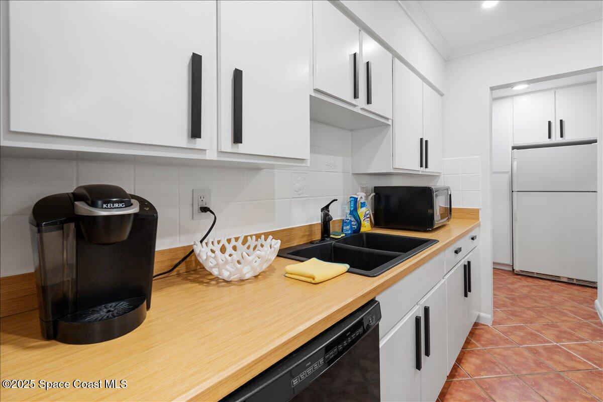 2175 Barracuda Avenue Melbourne Beach, FL 32951 - Photo 16 of 49 a kitchen with granite countertop a sink a stove and a refrigerator