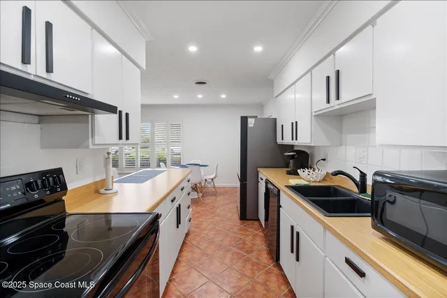 a kitchen with a sink stove and refrigerator
