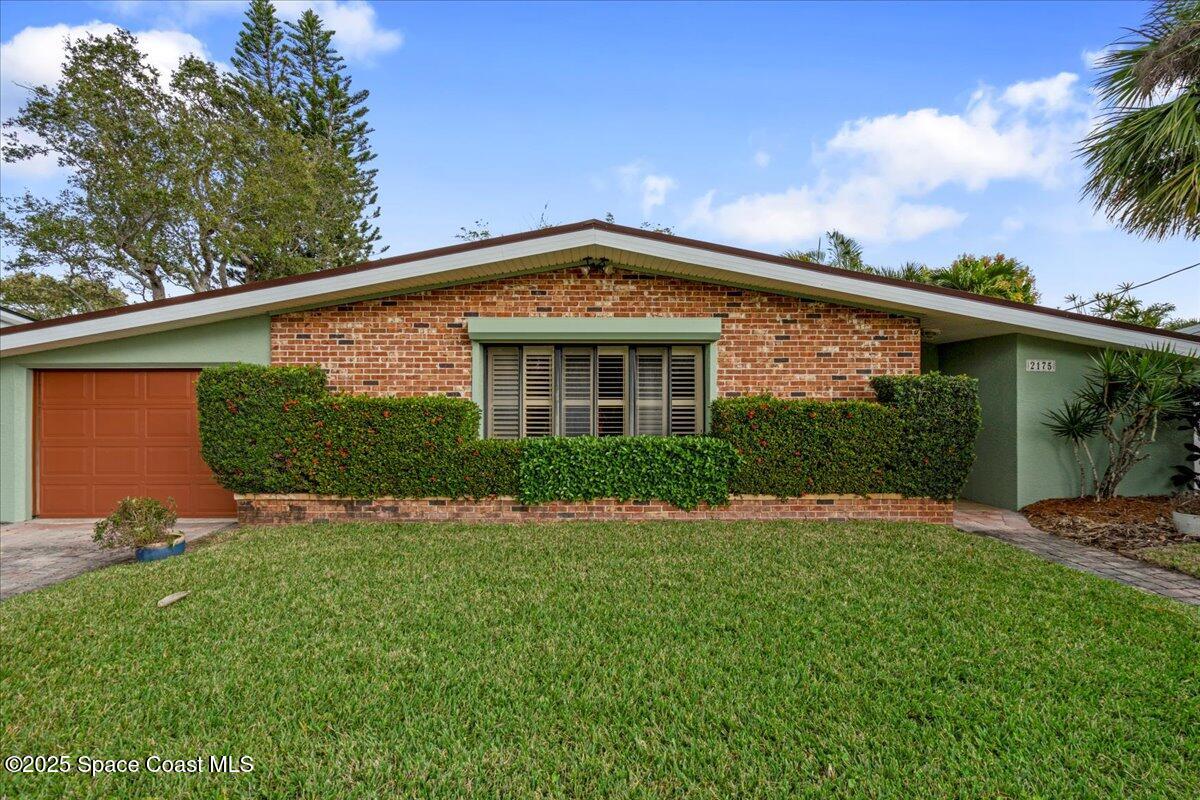 2175 Barracuda Avenue Melbourne Beach, FL 32951 - Photo 2 of 49 a front view of a house with a yard