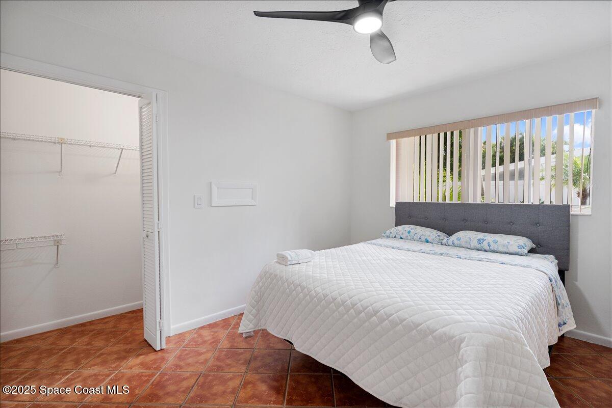 2175 Barracuda Avenue Melbourne Beach, FL 32951 - Photo 22 of 49 a bedroom with a bed and a window