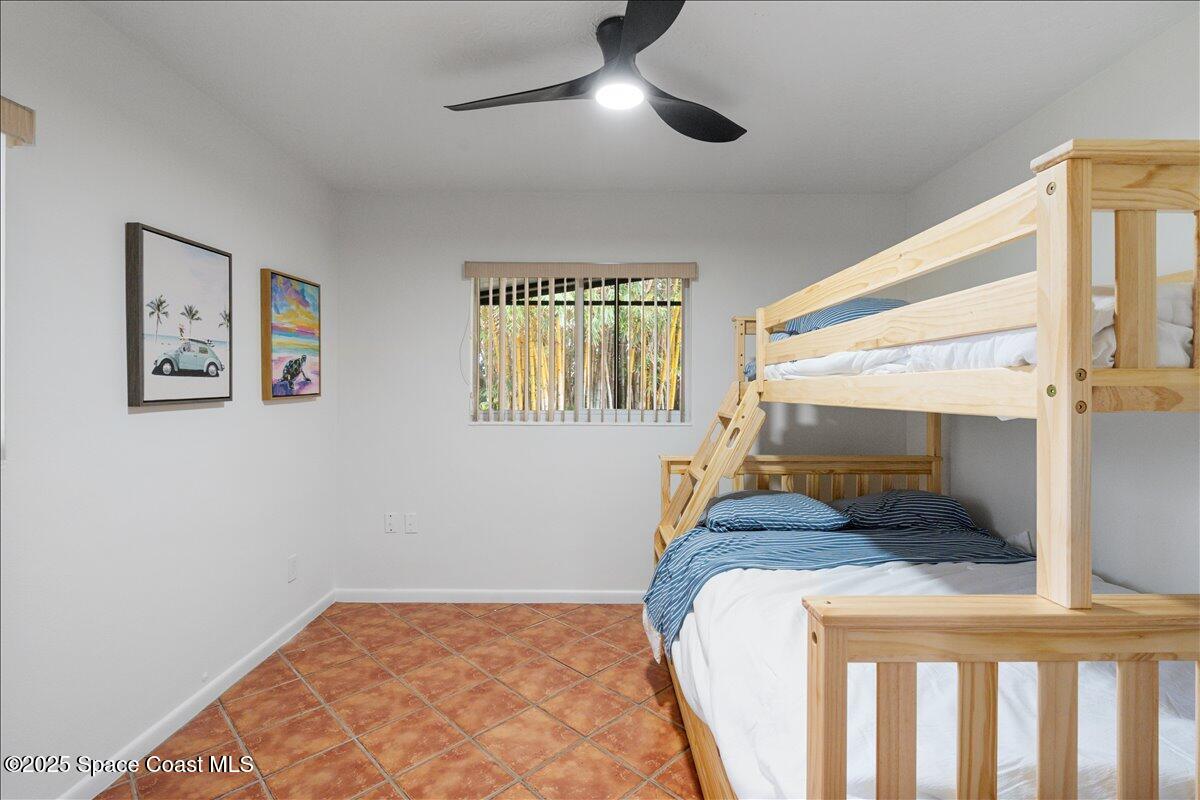 2175 Barracuda Avenue Melbourne Beach, FL 32951 - Photo 24 of 49 a bedroom with a bed and a window