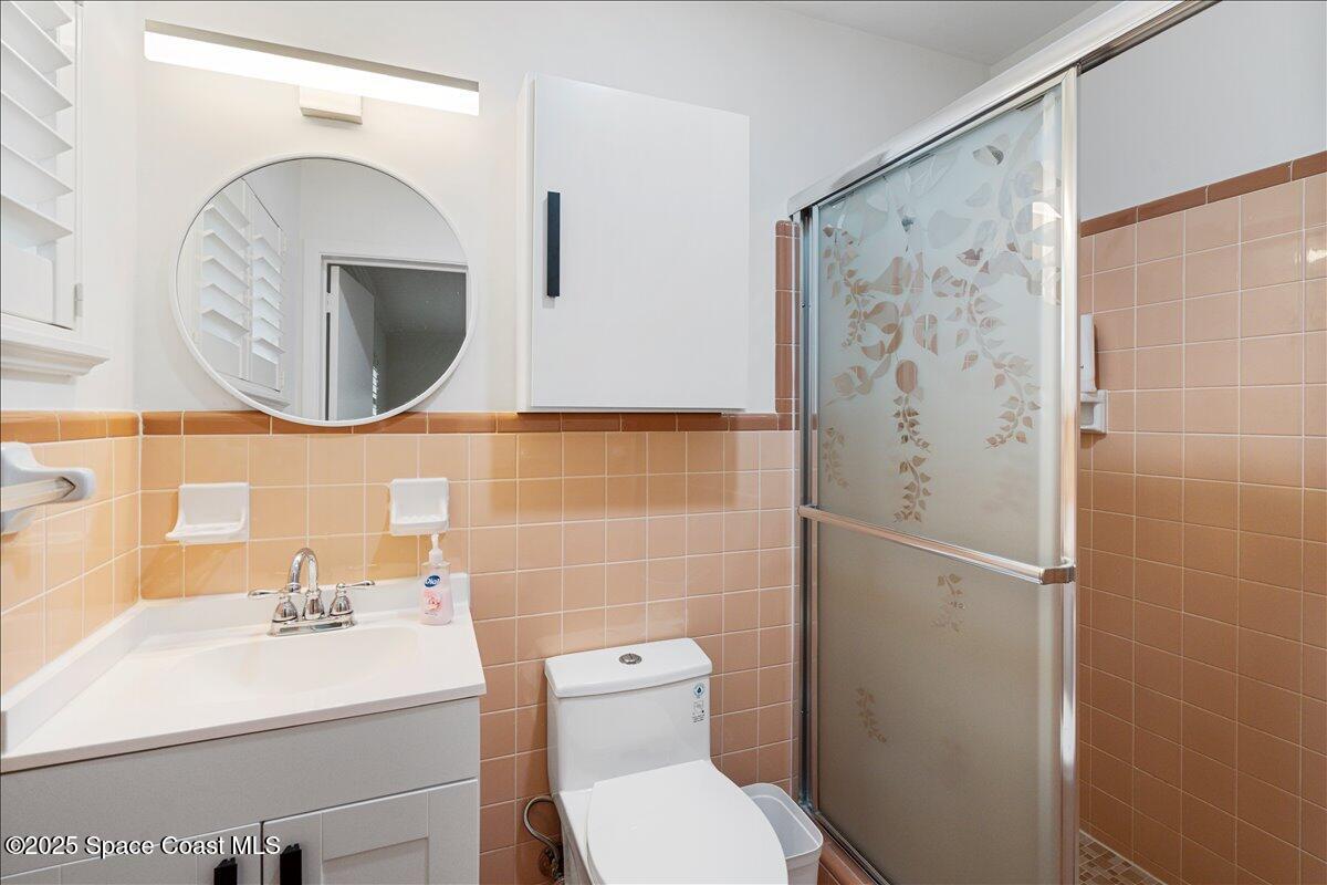 2175 Barracuda Avenue Melbourne Beach, FL 32951 - Photo 30 of 49 a bathroom with a sink a toilet and shower