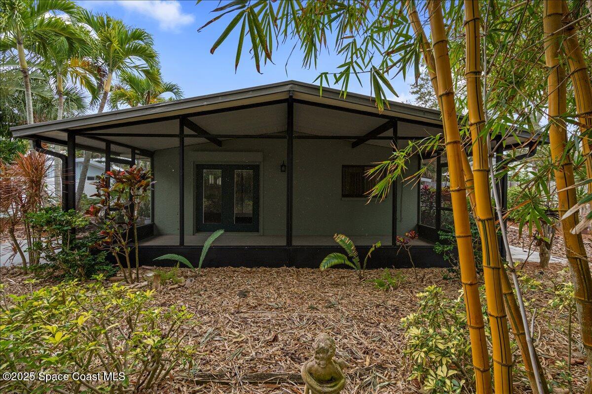 2175 Barracuda Avenue Melbourne Beach, FL 32951 - Photo 40 of 49 a front view of a house with garden