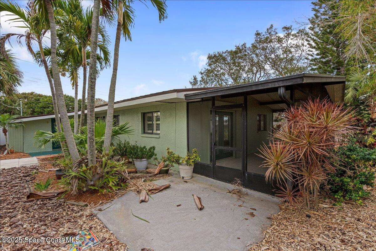 2175 Barracuda Avenue Melbourne Beach, FL 32951 - Photo 41 of 49 a front view of a house with garden
