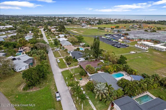 an aerial view of residential houses with outdoor space