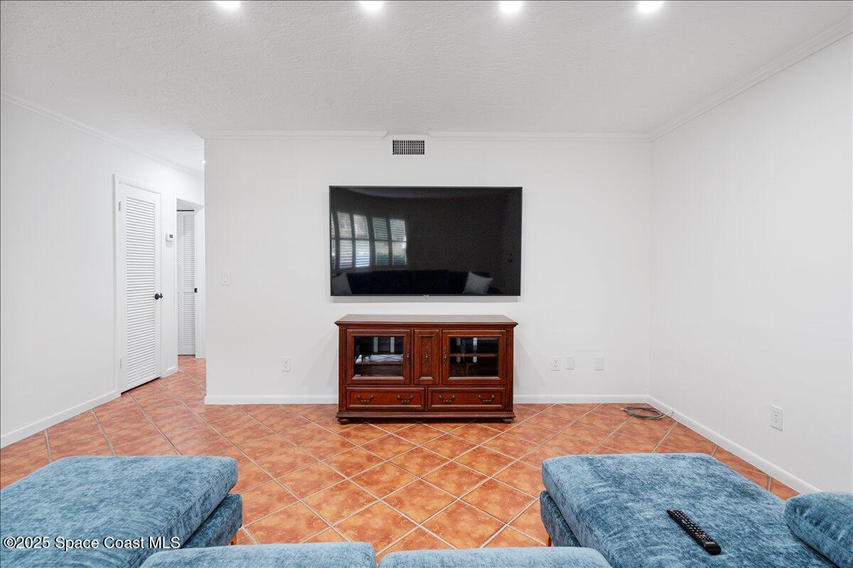 2175 Barracuda Avenue Melbourne Beach, FL 32951 - Photo 7 of 49 a living room with furniture and a flat screen tv