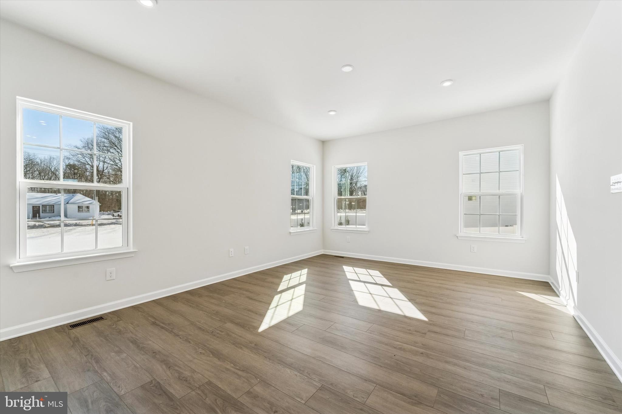 56 Mockernut Road Williamstown, NJ 08094 - Photo 11 of 29 an empty room with wooden floor and windows