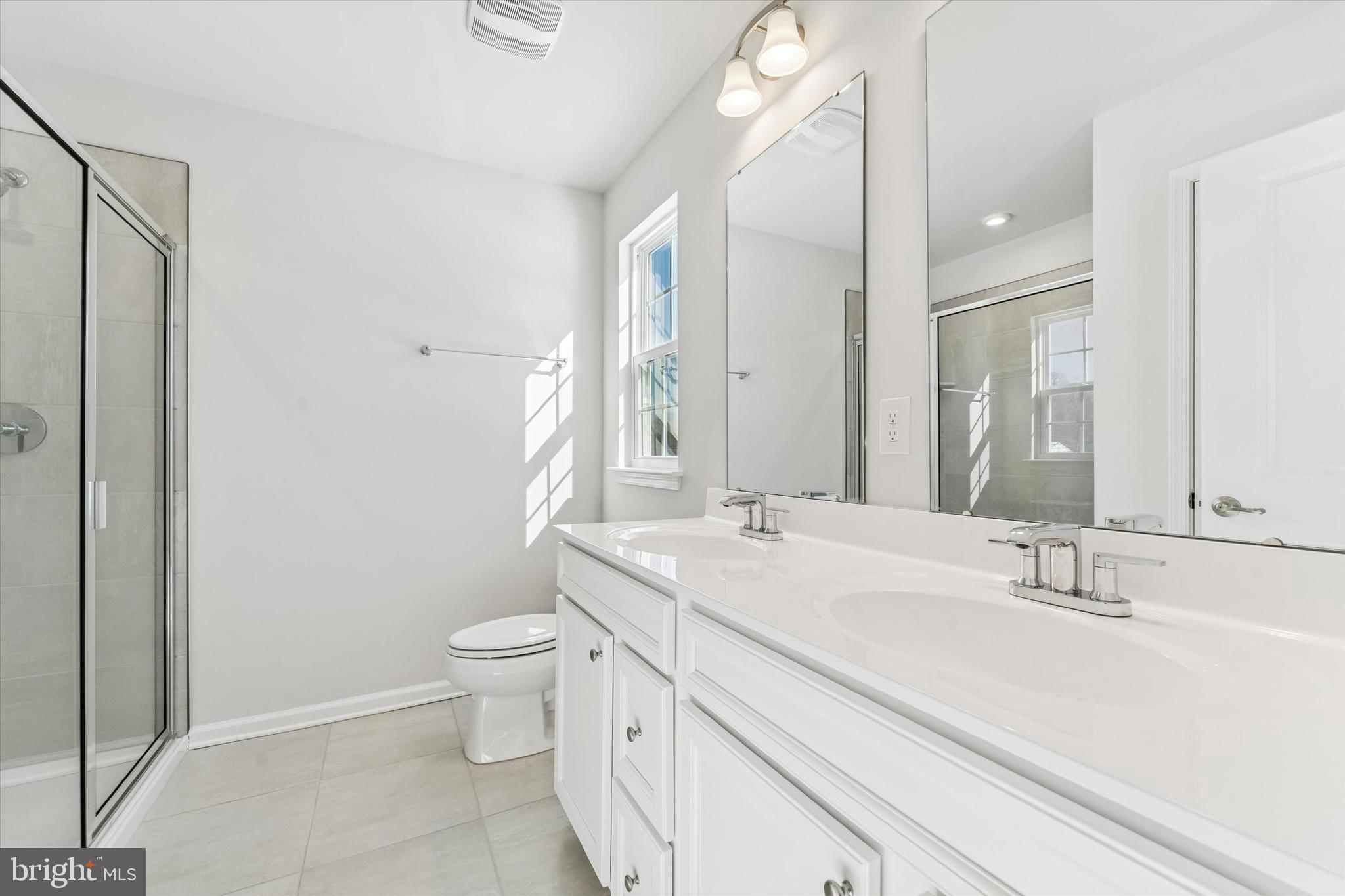 56 Mockernut Road Williamstown, NJ 08094 - Photo 15 of 29 a bathroom with a sink a toilet a large mirror and shower