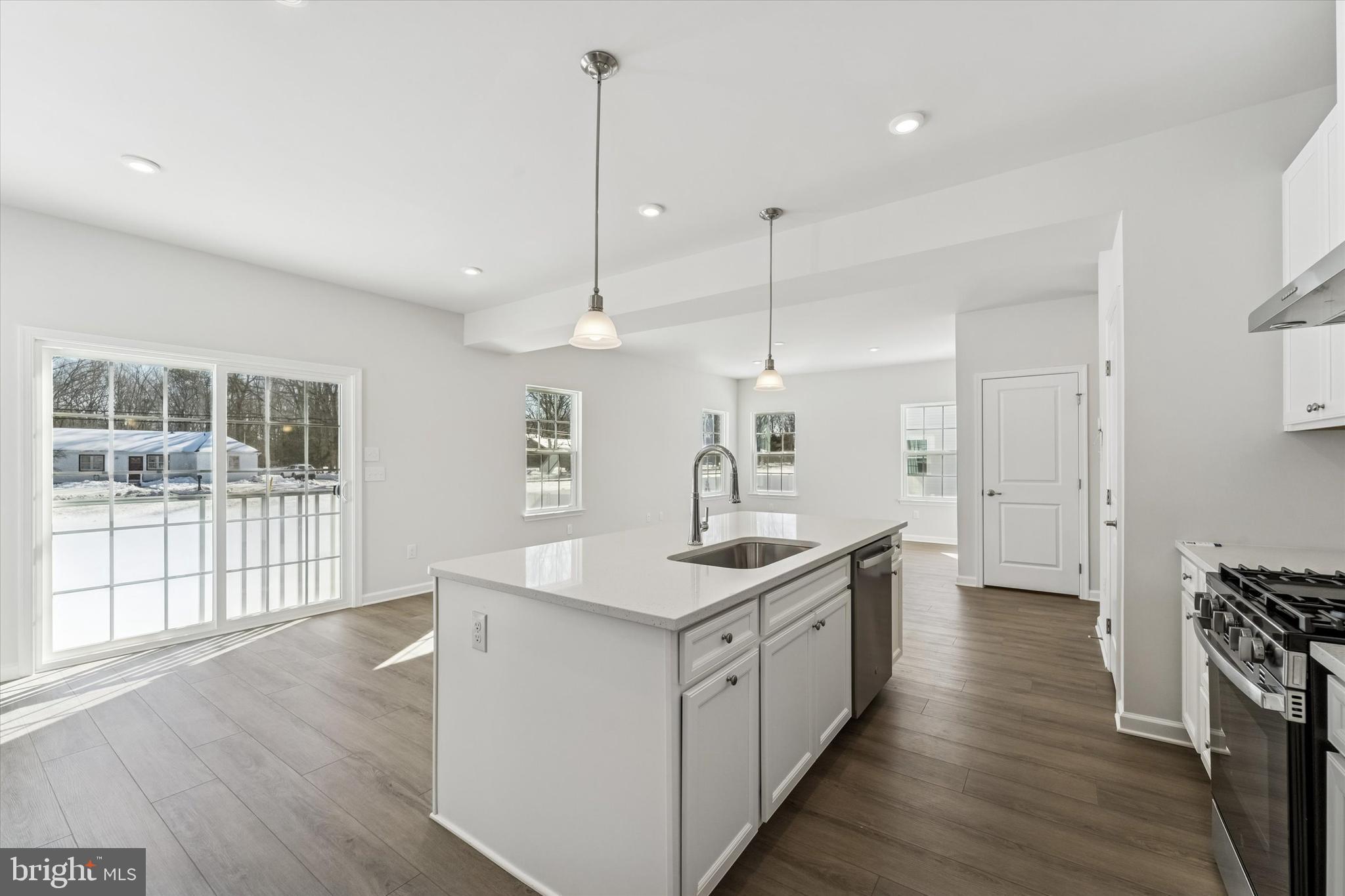 56 Mockernut Road Williamstown, NJ 08094 - Photo 7 of 29 a kitchen with stainless steel appliances kitchen island a sink stove and wooden floor