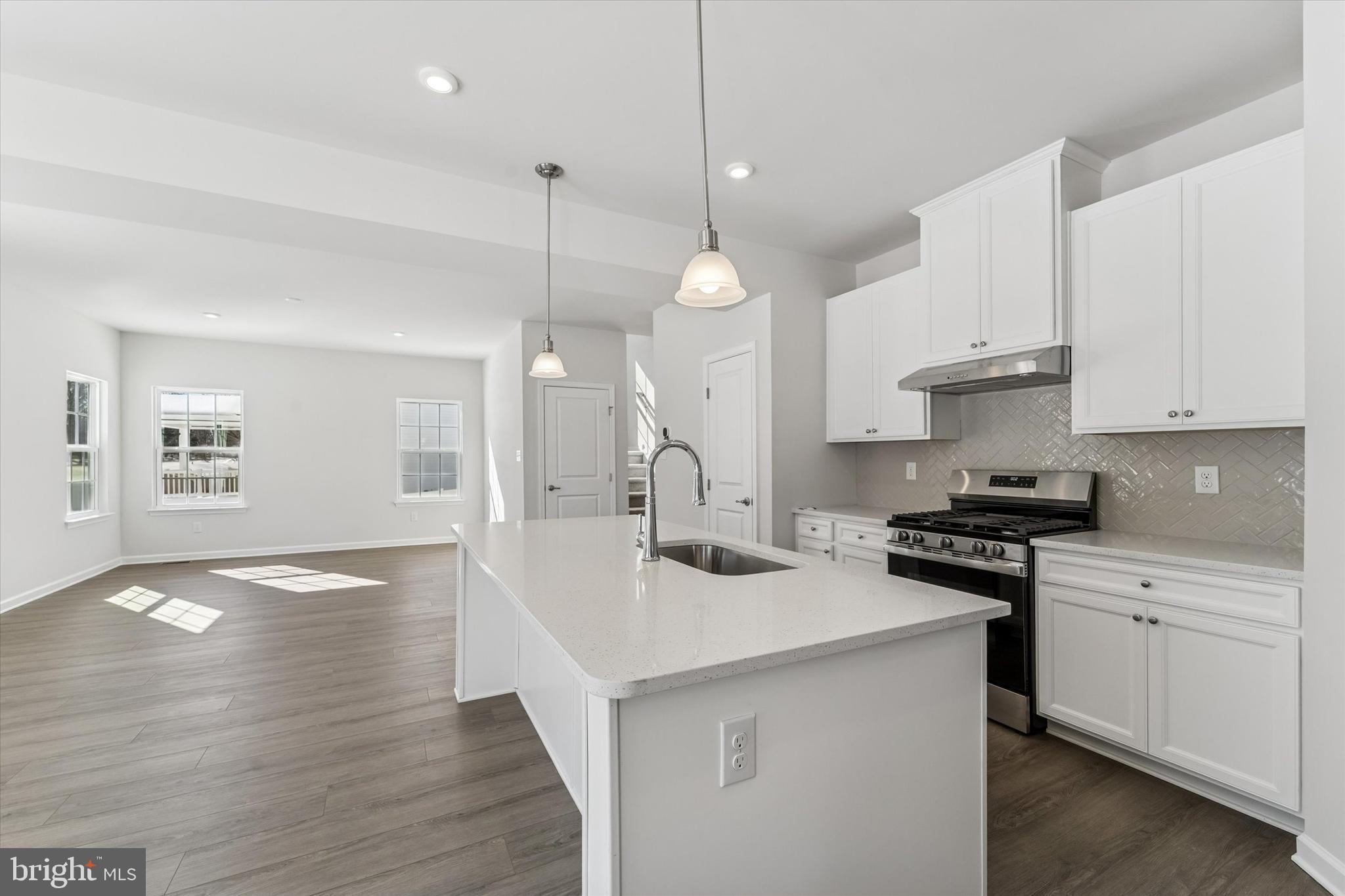 56 Mockernut Road Williamstown, NJ 08094 - Photo 9 of 29 a kitchen with granite countertop a sink a stove and cabinets