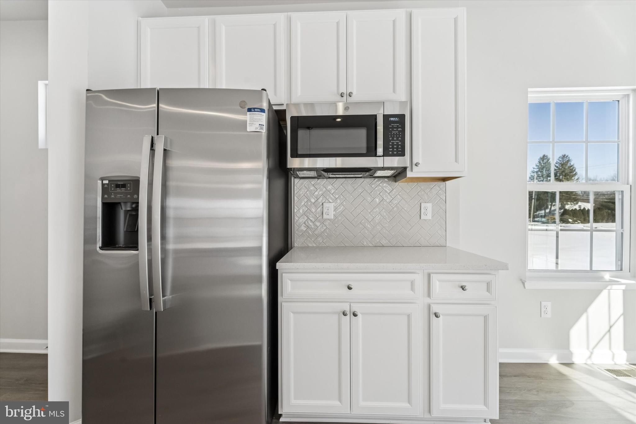 56 Mockernut Road Williamstown, NJ 08094 - Photo 10 of 29 a kitchen with white cabinets and stainless steel appliances