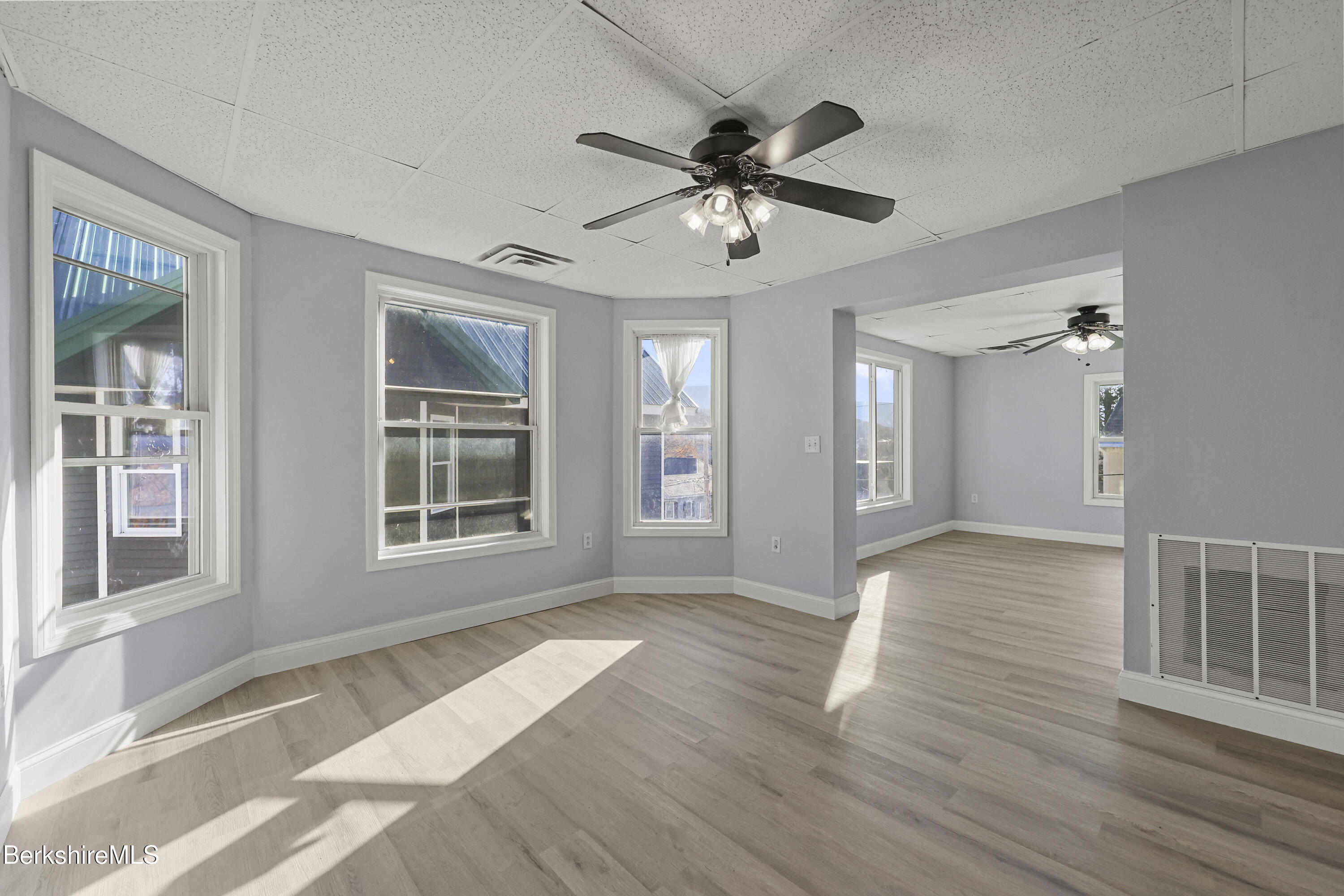 73-75 Hall Street North Adams, MA 01247 - Photo 11 of 32 a view of an empty room with wooden floor and a window