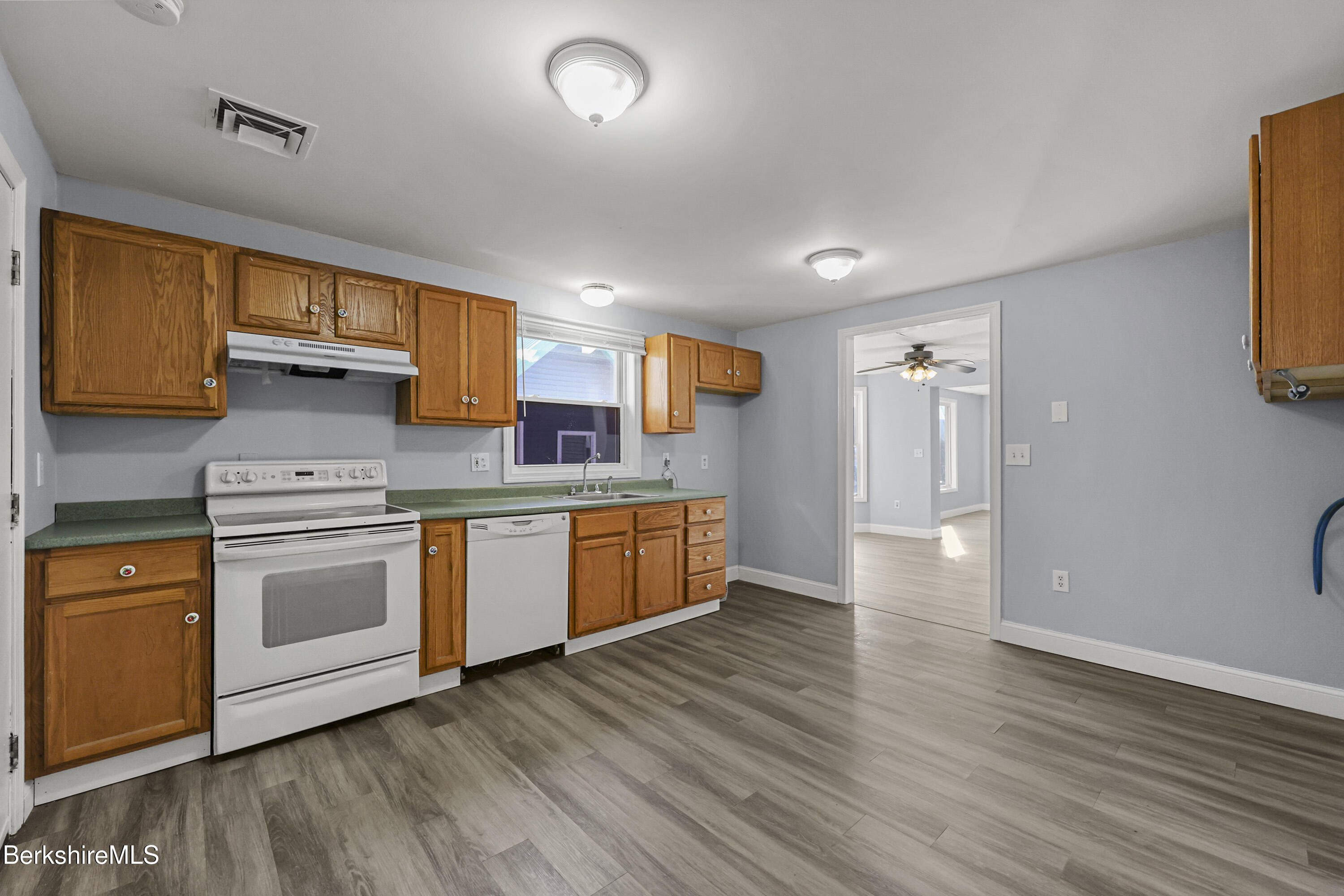 73-75 Hall Street North Adams, MA 01247 - Photo 12 of 32 a kitchen with stainless steel appliances granite countertop a stove a sink and a refrigerator