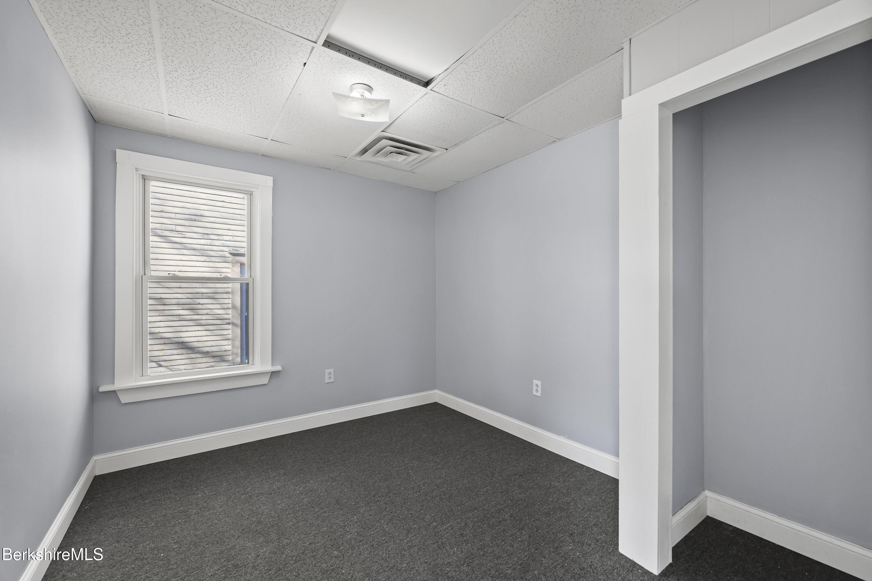 73-75 Hall Street North Adams, MA 01247 - Photo 21 of 32 an empty room with windows and closet