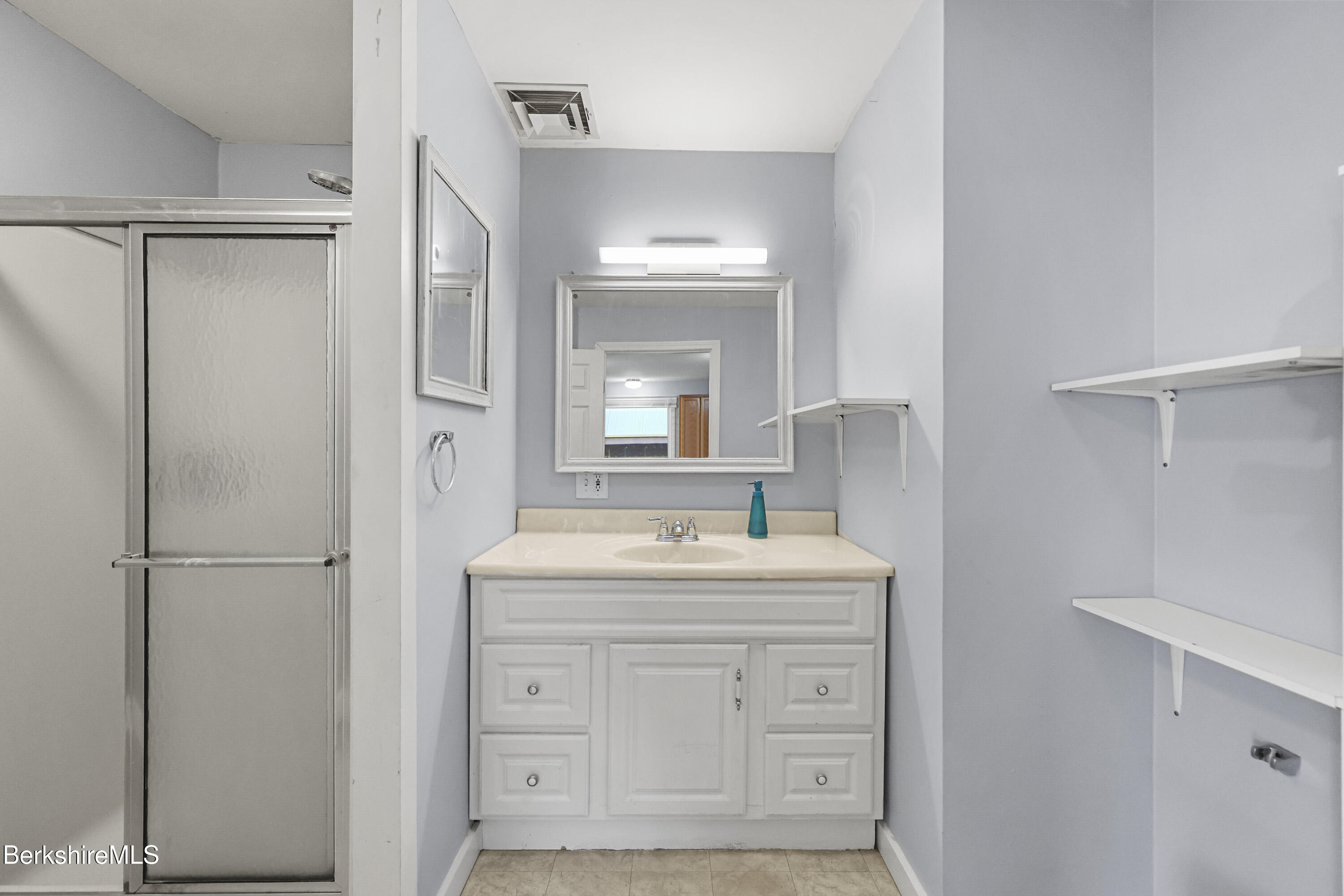 73-75 Hall Street North Adams, MA 01247 - Photo 22 of 32 a bathroom with a sink a mirror and a shower