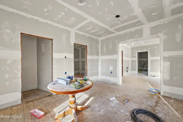 an empty room with windows and closet