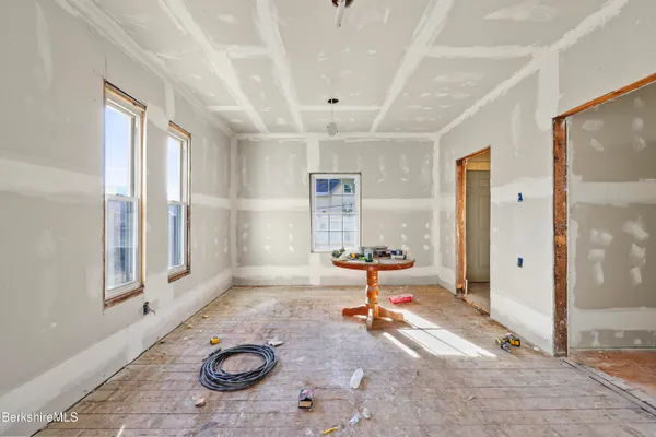 an empty room with windows and closet