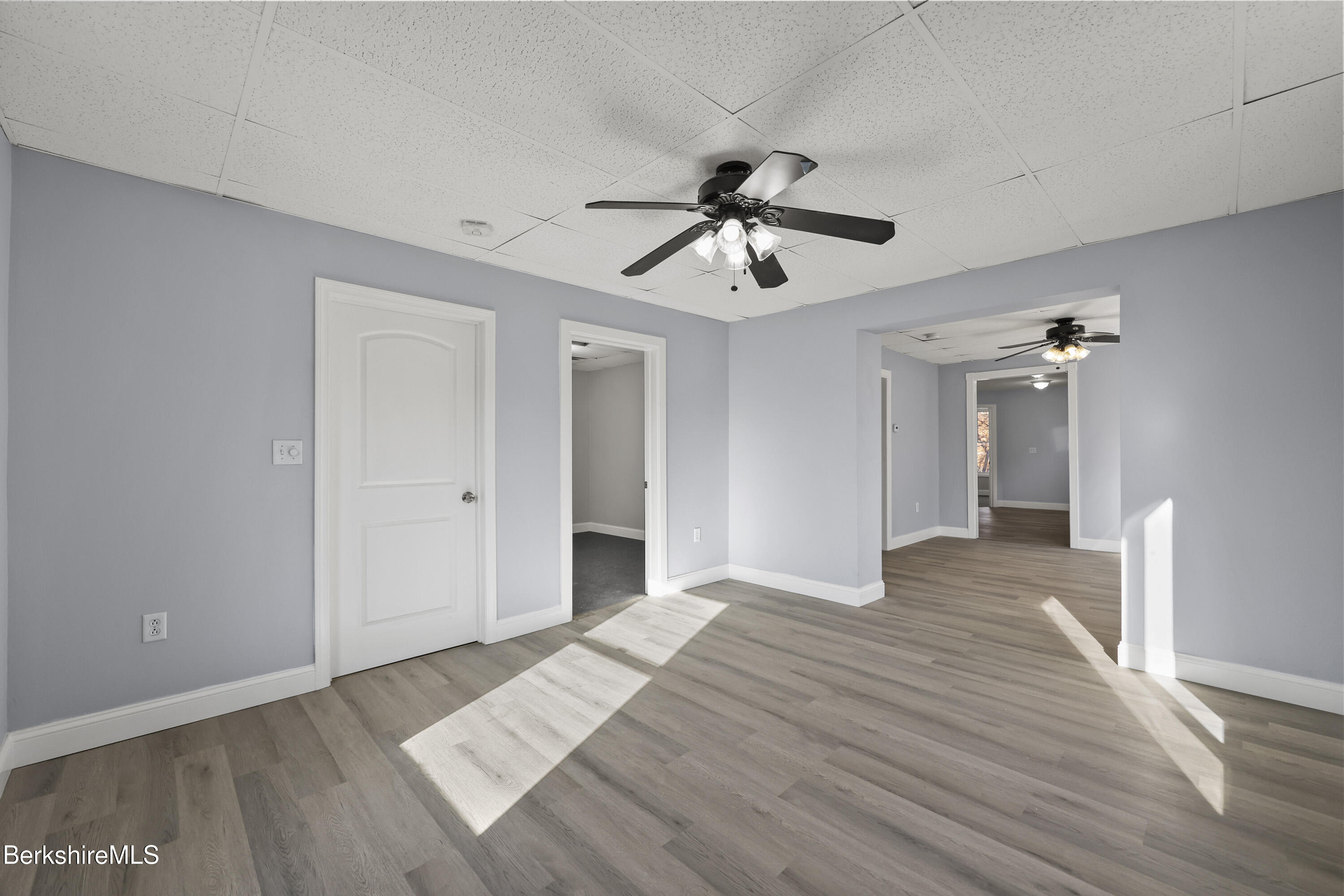 73-75 Hall Street North Adams, MA 01247 - Photo 4 of 32 a view of empty room with wooden floor and ceiling fan