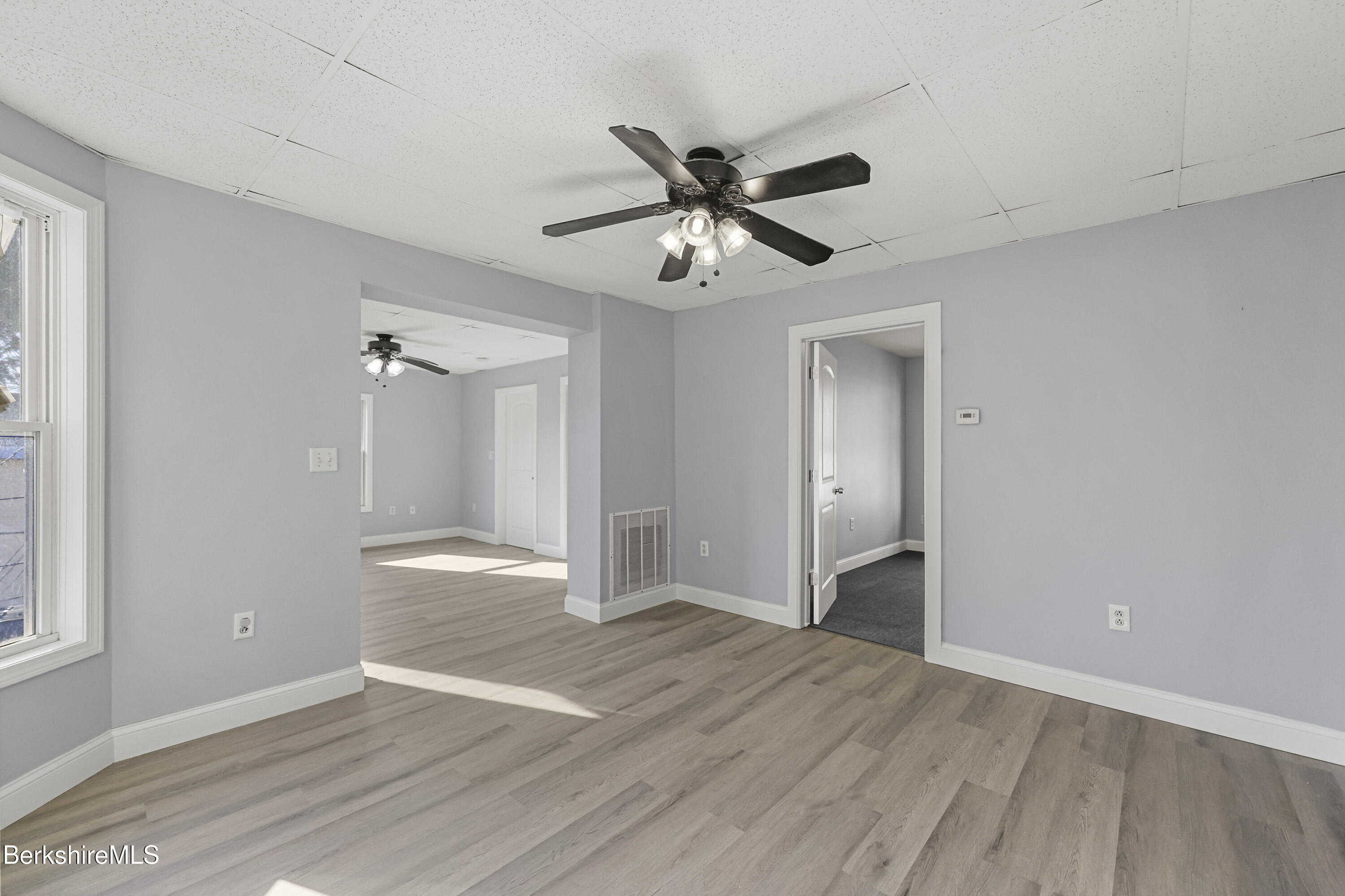 73-75 Hall Street North Adams, MA 01247 - Photo 10 of 32 a view of an empty room and window and wooden floor