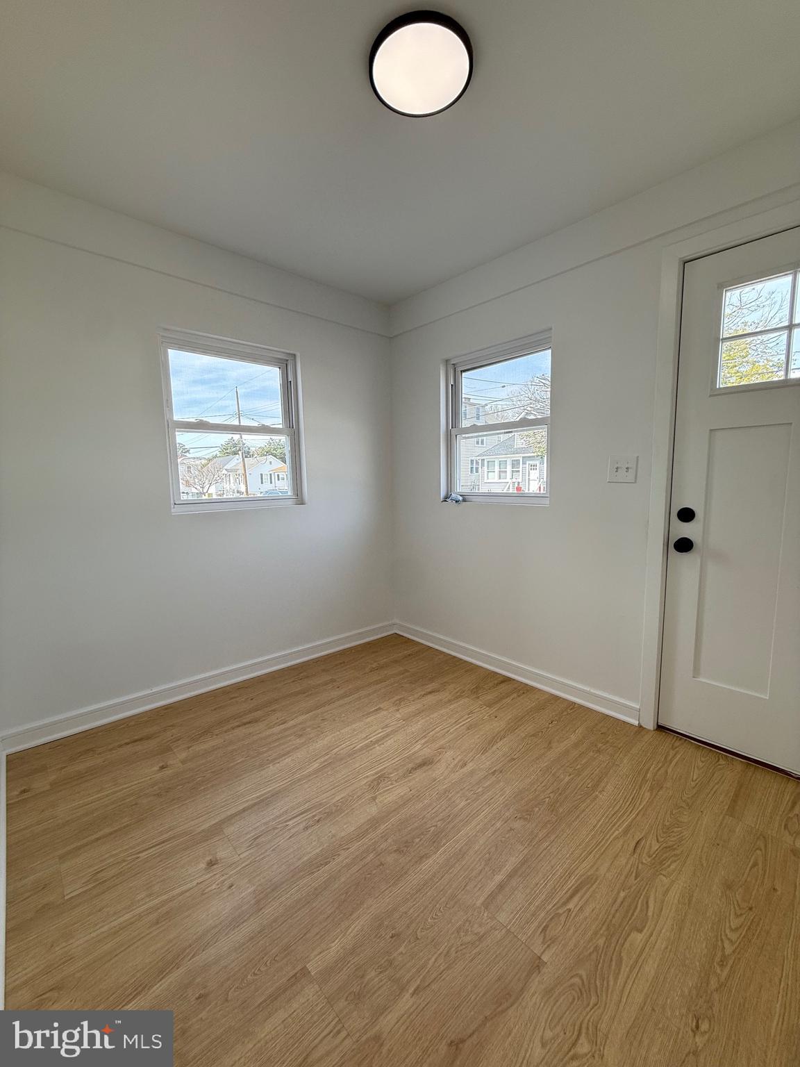 2125 Oakland Road Middle River, MD 21220 - Photo 7 of 15 an empty room with wooden floor and windows