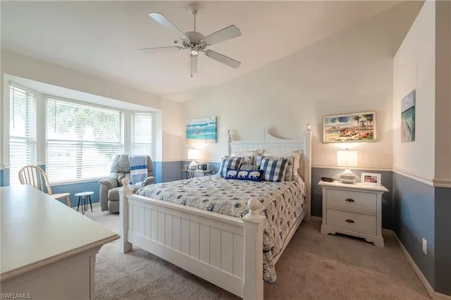 a bedroom with a bed a couch and dresser