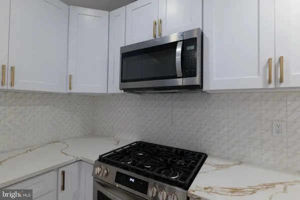 a kitchen with a stove and a microwave