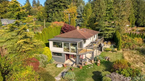 a aerial view of a house with a yard and potted plants