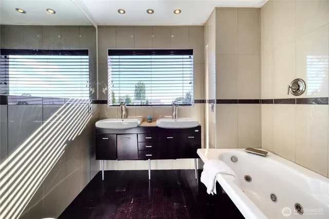 a bathroom with a glass shower door and a sink
