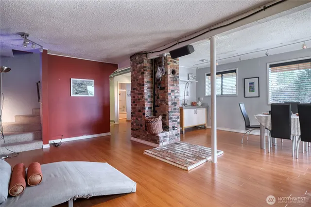 a living room with furniture and a wooden floor
