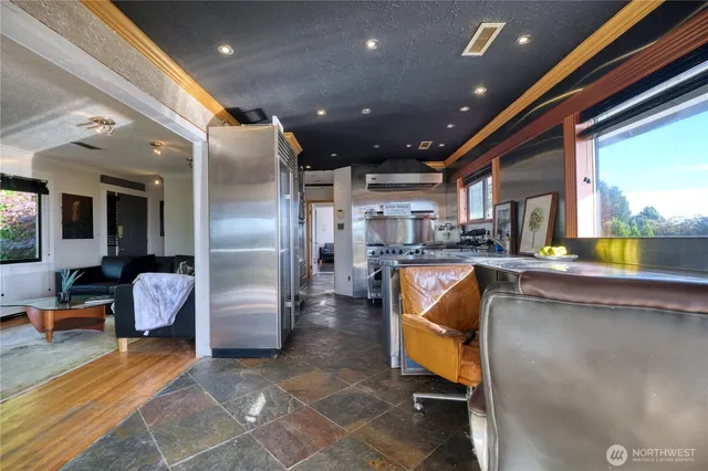 a kitchen with stainless steel appliances granite countertop a refrigerator a oven a sink and dishwasher