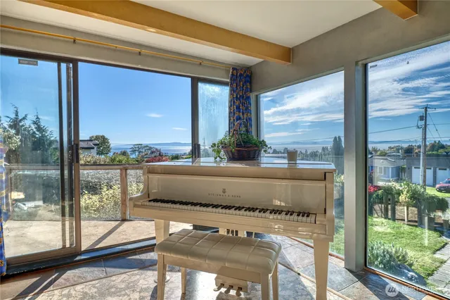 a view of living room with a floor to ceiling window and wooden floor