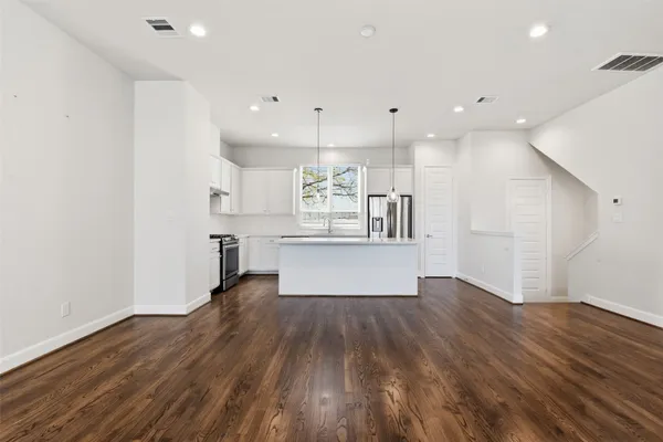 a view of kitchen with wooden floor and window