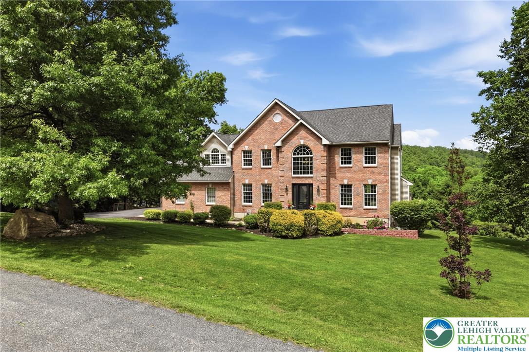 115 West Butternut Road Hellertown, PA 18055 - Photo 93 of 97 Brick facade home on a sprawling green lawn with mature trees and thoughtful landscaping.