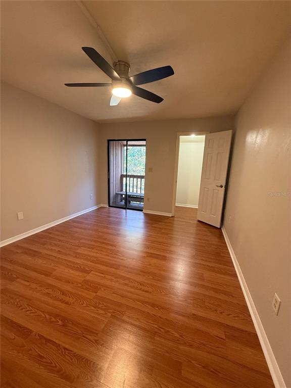 1515 Northwest 29 Road, Unit D2 Gainesville, FL 32605 - Photo 14 of 23 an empty room with wooden floor and windows